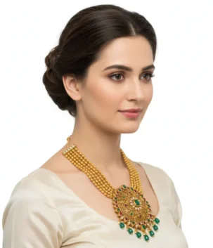Gold necklace with green stones and ornate round pendant